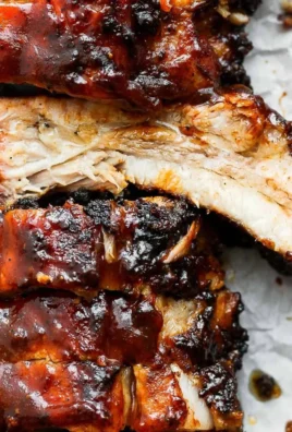 Deliciously grilled ribs served with barbecue sauce and sides