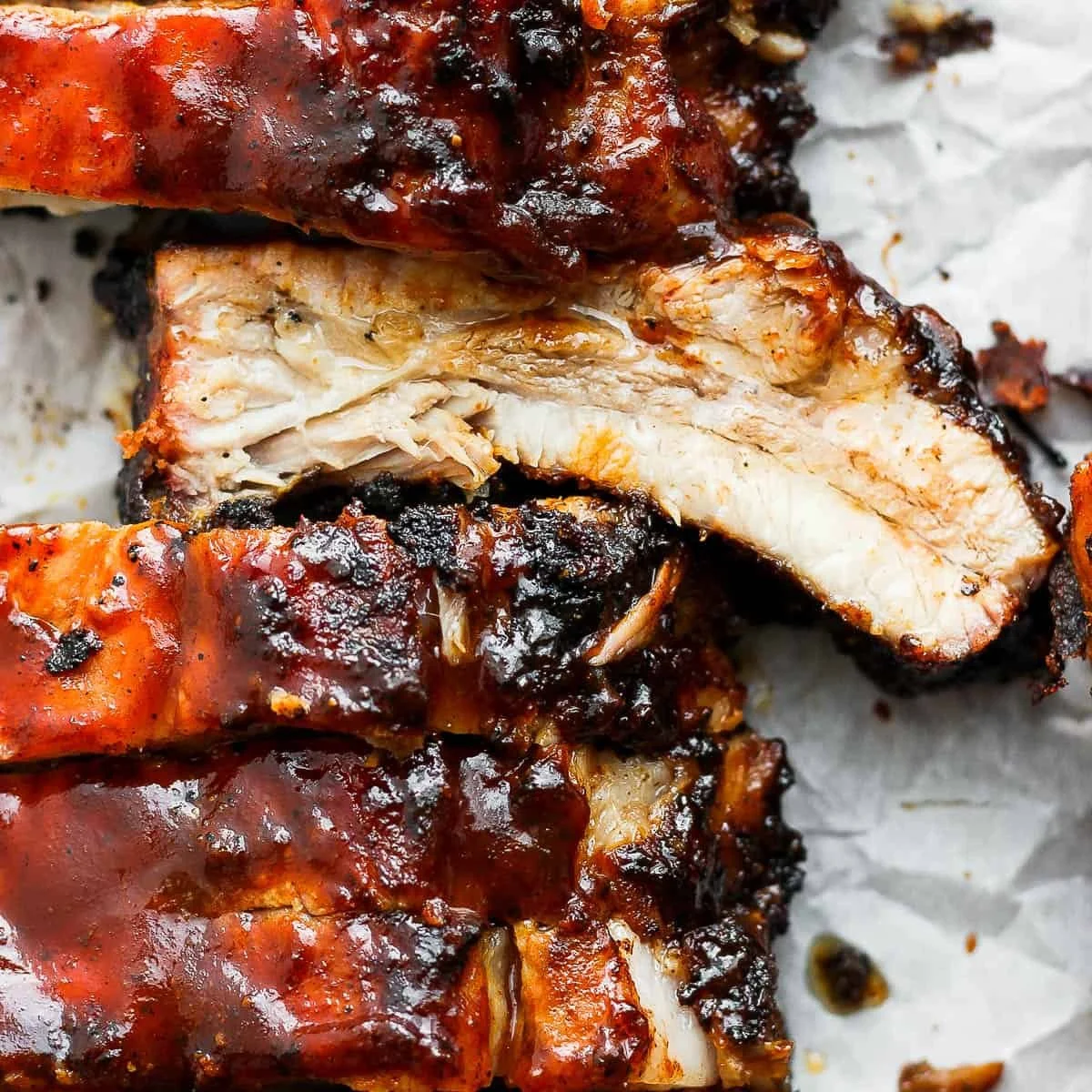 Deliciously grilled ribs served with barbecue sauce and sides