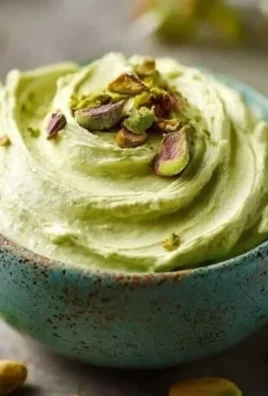 Homemade Italian-style pistachio cream in a jar with a spoon.
