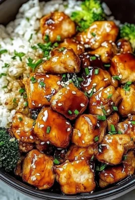 Hot Honey Chicken Bowl garnished with herbs and served in a vibrant bowl