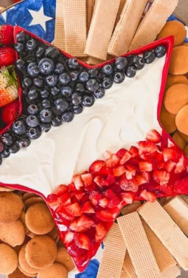 Star Spangled Cheesecake Dip in a festive bowl with red, white, and blue toppings.