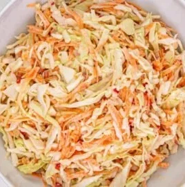 Bowl of colorful Jamaican coleslaw with fresh vegetables and spices