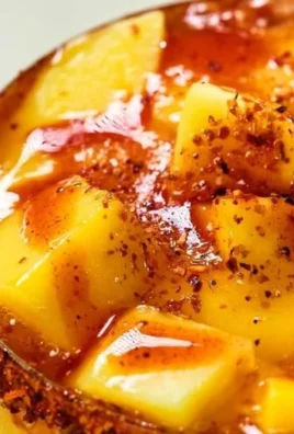 Delicious mango slushie topped with fresh mango slices