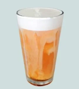 Fluffy salted caramel cold foam topping on coffee drink