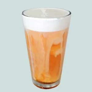 Fluffy salted caramel cold foam topping on coffee drink