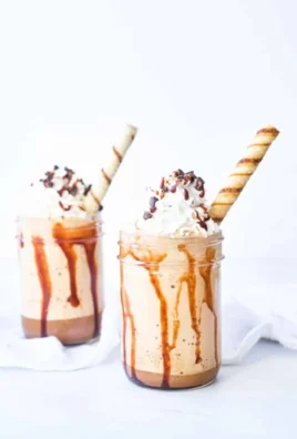 A refreshing Mocha Frappuccino topped with whipped cream and chocolate drizzle