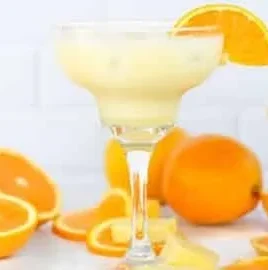 Refreshing Orange, Pineapple & Coconut Mocktail served in a glass