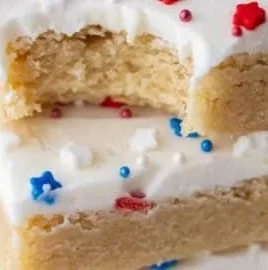Patriotic sugar cookie bars decorated with red, white, and blue icing.