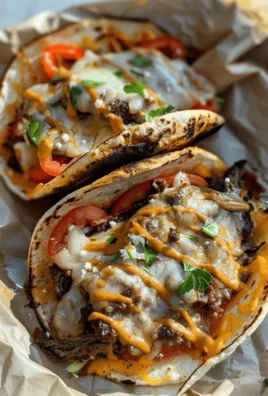 Delicious Philly Cheesesteak Tacos with melted cheese and grilled onions