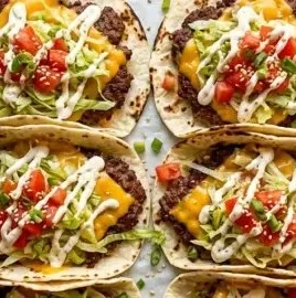 Smash burger tacos served on a plate with fresh toppings