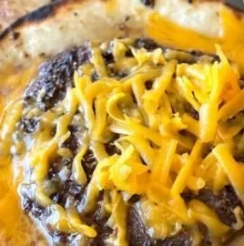 Smashed cheeseburger tacos served with salsa and toppings on a plate