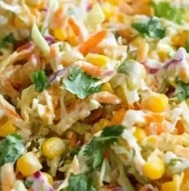 Bowl of spicy corn slaw with fresh ingredients and vibrant colors, perfect for summer meals.