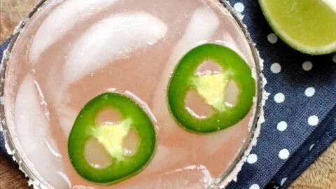 Spicy Paloma cocktail garnished with lime and jalapenos