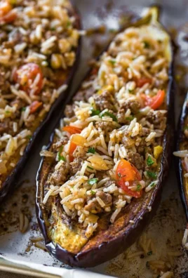 Delicious stuffed eggplant drizzled with garlic tahini sauce on a plate