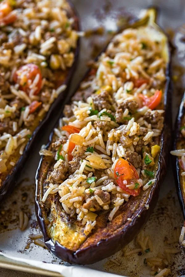 Delicious stuffed eggplant drizzled with garlic tahini sauce on a plate