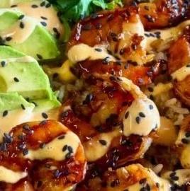 Delicious teriyaki shrimp rice bowl with vibrant vegetables and savory sauce