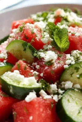 Colorful Watermelon Cucumber Feta Salad served in a bowl with mint garnish