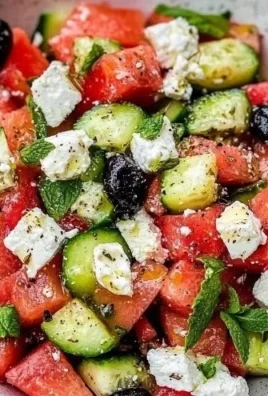 Delicious watermelon cucumber feta salad with lime dressing in a bowl