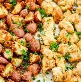 Delicious Baked Garlic Parmesan Chicken served with crispy roasted potatoes.