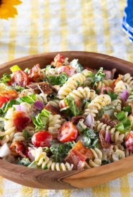 Colorful BLT Pasta Salad with bacon, lettuce, and tomatoes in a serving bowl