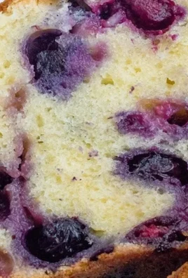 Delicious slice of Blueberry Cream Cheese Loaf with fresh blueberries
