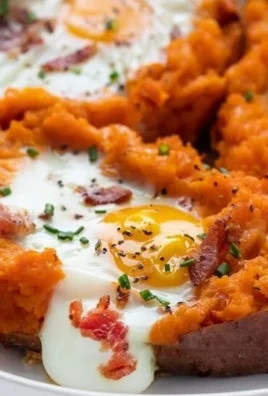 Delicious breakfast sweet potato topped with eggs and herbs