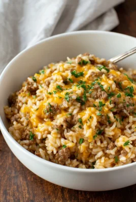 Cheesy ground beef and rice casserole served in a baking dish