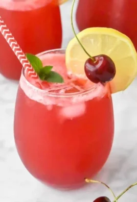 Refreshing glass of Cherry Lemonade with cherries and lemon slices