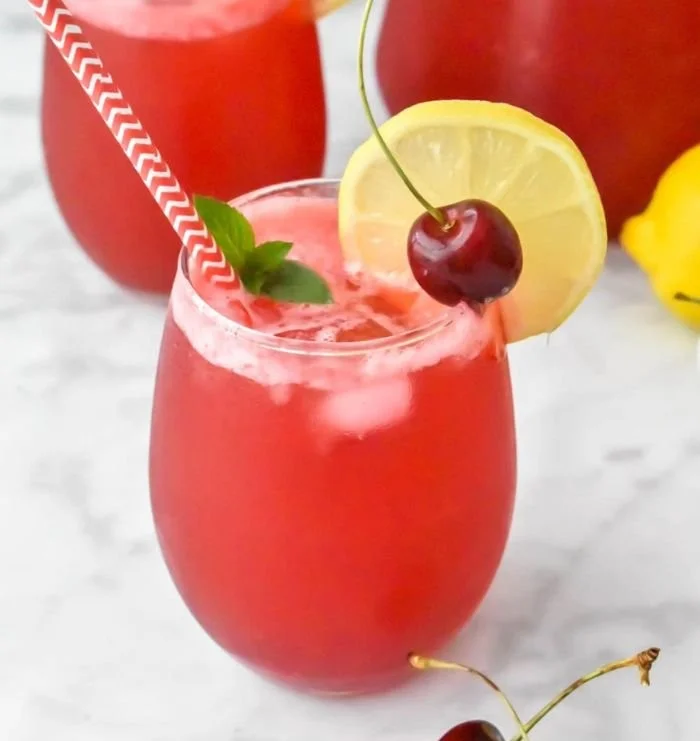 Refreshing glass of Cherry Lemonade with cherries and lemon slices