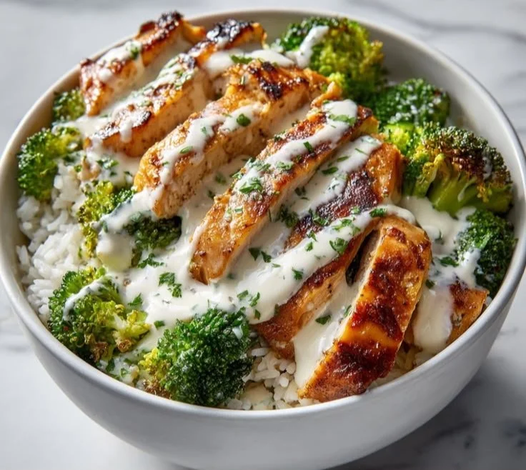 Chicken and broccoli bowls with creamy garlic sauce served in a rustic bowl.