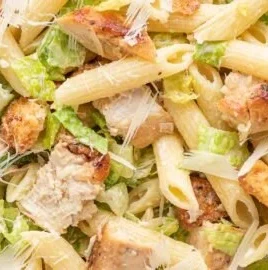 Bowl of Chicken Caesar Pasta Salad with chicken, romaine, and Caesar dressing