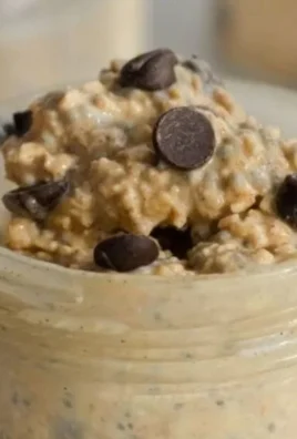 Chocolate chip cookie dough overnight oats served in a bowl with chocolate chips on top.