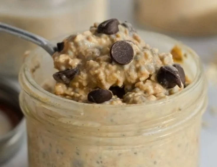 Chocolate chip cookie dough overnight oats served in a bowl with chocolate chips on top.