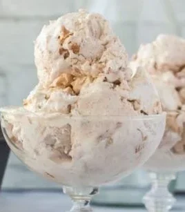 Cinnamon Toast Crunch ice cream scoop in a bowl with cereal pieces