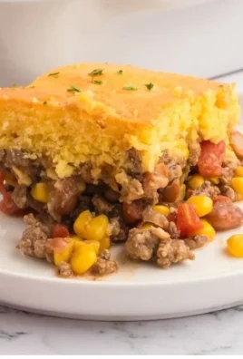 Delicious Cowboy Cornbread Casserole served in a dish, topped with cheese and jalapeños.
