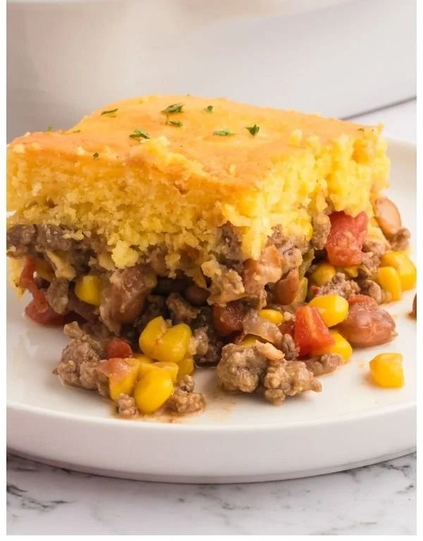Delicious Cowboy Cornbread Casserole served in a dish, topped with cheese and jalapeños.
