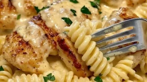 Creamy garlic butter chicken with rotini pasta in parmesan sauce served in a bowl