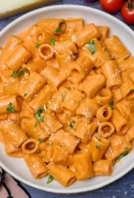 Creamy tomato pasta sauce served over spaghetti with basil garnish