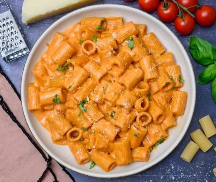 Creamy tomato pasta sauce served over spaghetti with basil garnish