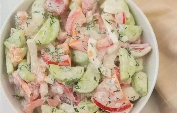 Fresh Cucumber Tomato Salad served in a bowl with herbs