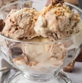 Bowl of homemade Snickers ice cream with chocolate and caramel toppings