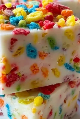 Delicious Fruity Pebbles Fudge topped with colorful cereal pieces