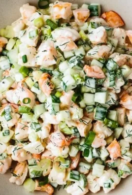 Healthy cucumber shrimp salad with fresh vegetables and dressing