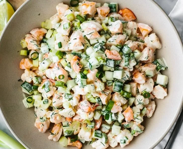 Healthy cucumber shrimp salad with fresh vegetables and dressing