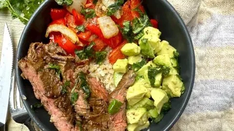 Delicious high protein steak fajita bowl with colorful vegetables and spices
