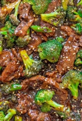 Delicious homemade beef and broccoli served on a plate with sauce.