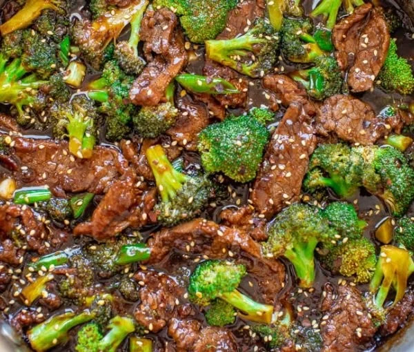 Delicious homemade beef and broccoli served on a plate with sauce.