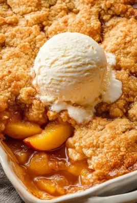 Delicious peach cobbler prepared using Joanna Gaines recipe, topped with golden crust.