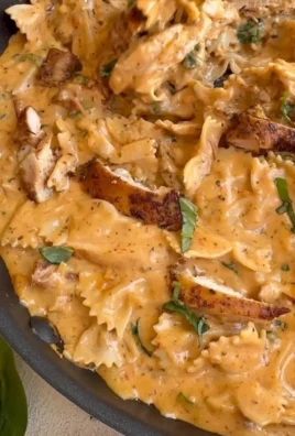 Plate of creamy Marry Me Chicken Pasta garnished with herbs