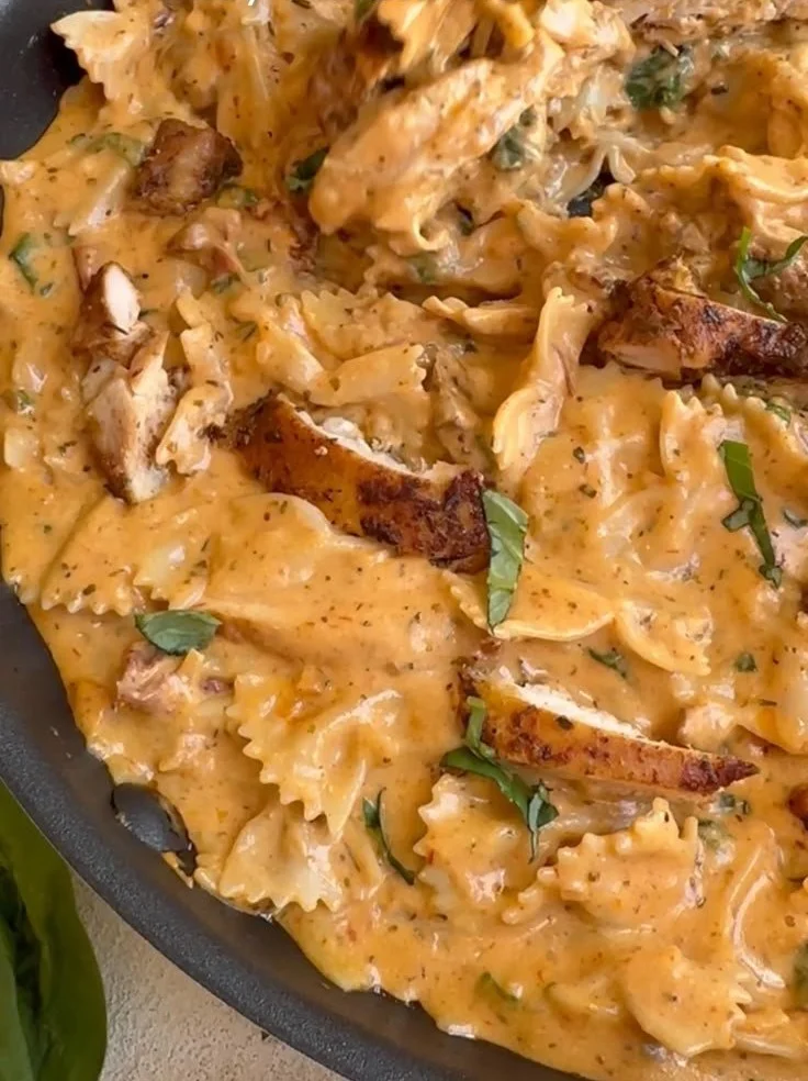 Plate of creamy Marry Me Chicken Pasta garnished with herbs